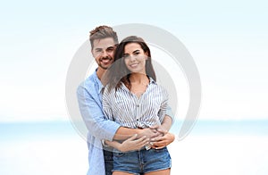 Happy young couple spending time  on beach