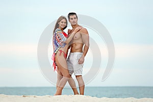 Happy young couple spending time  on sea beach