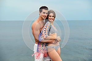 Happy young couple spending time  on sea beach