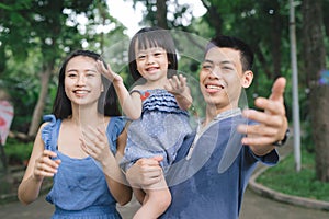 Happy young couple spending time with their daughter