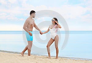 Happy young couple spending time together on beach