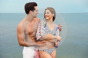 Happy young couple spending time together on beach