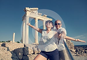 Happy young couple take a selfie photo on antique ruins