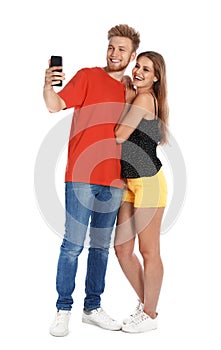 Happy young couple taking selfie on white