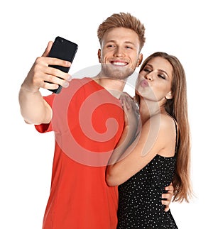 Happy young couple taking selfie on white