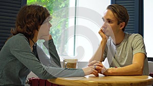 Happy young couple talking in cafe with mediterrian style