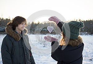 Happy young couple of teenagers walking in winter. feelings of love