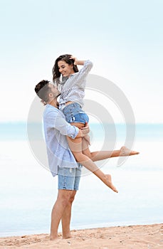 Happy young couple  time together on beach near sea