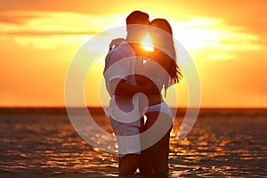 Happy young couple  time together on sea beach at sunset