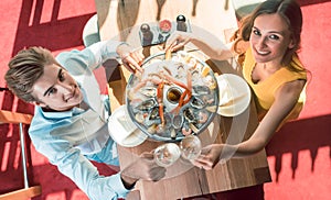 Happy young couple toasting during romantic dinner at a trendy restaurant