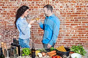 Happy Young Couple Toasting with White Wine