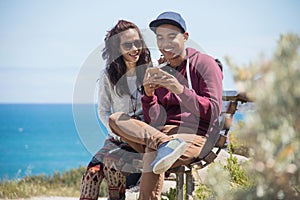 Happy young couple together using mobile phone