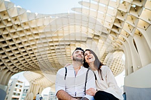 Happy young couple tourists visiting Setas de Seville aka Metropol Parasol, site seeing attractions.Vacation in south of Spain,