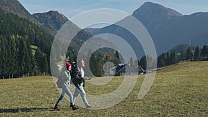 Happy young couple of travelers hiking with map and looking area. Millennials with backpack traveling highlands on