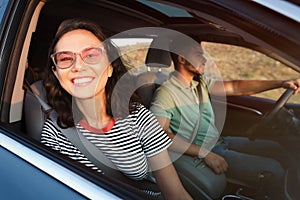 Happy young couple traveling by family car