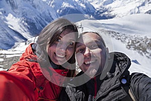 Happy young couple on vacation in the mountains, taking a selfie