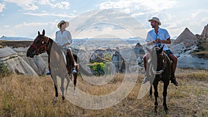 happy young couple on vacation Turkey Kapadokya horse riding in the mountains of Cappadocia Goreme