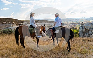 happy young couple on vacation Turkey Kapadokya horse riding in the mountains of Cappadocia Goreme