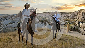 happy young couple on vacation Turkey Kapadokya horse riding in the mountains of Cappadocia Goreme