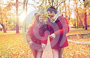 Happy young couple walking in autumn park