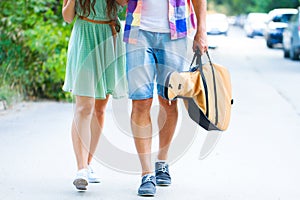 Happy young couple walking with guitar drinking juice spending c