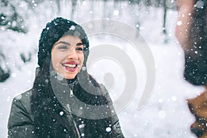 Happy Young Couple in Winter . Family Outdoors. man and woman looking upwards and laughing. Love, fun, season and people