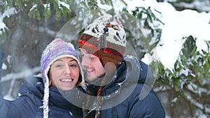 Happy young couple in a winter forest.
