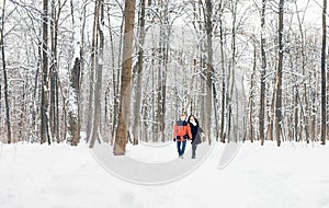 Happy Young Couple in Winter Park having fun. Family Outdoors