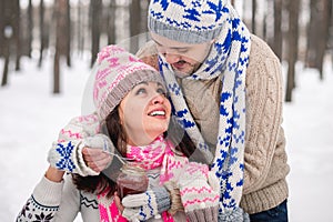 Happy Young Couple in Winter Park having fun.Family Outdoors. love kiss