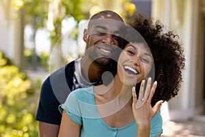 Happy young couple with woman showing her wedding ring photo