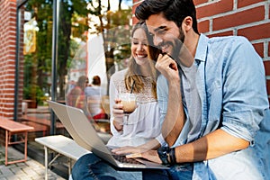 Happy young couple working studying on laptop and digital devices. Business education people concept