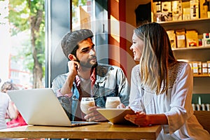 Happy young couple working studying on laptop and digital devices. Business education people concept