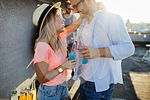 Happy young dancing couple having fun and enjoying party at summer