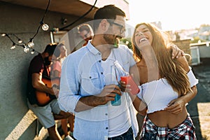 Happy young dancing couple having fun and enjoying party at summer