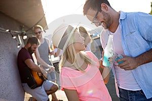 Happy young dancing couple having fun and enjoying party at summer