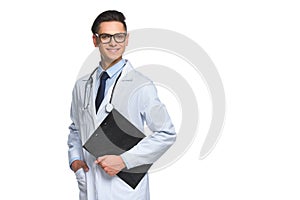 happy young doctor with clipboard looking at camera