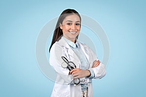 Happy young doctor in lab coat with a stethoscope