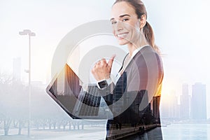 Happy young employee with a laptop looking satisfied