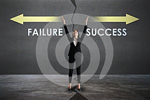 Happy young european businesswoman choosing between failure and success arrows sketch on concrete background. Direction, growth,