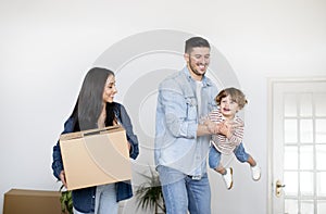 Happy Young European Family Of Three Having Fun On Moving Day