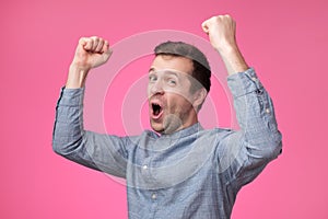 Happy young european man gesturing and smiling