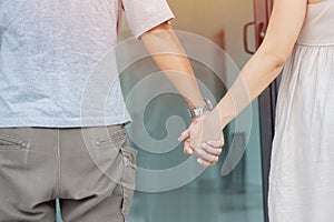 Happy young family bought new house. Young married couple wife and husband having fun laugh into modern home