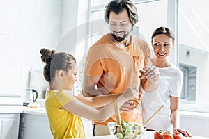 happy young family cooking together and having fun