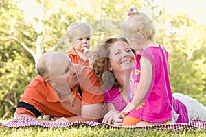 Happy Young Family with Cute Twins in Park