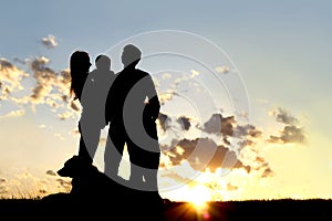 Happy Young Family and Dog Silhouette at Sunset