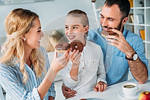 happy young family eating chocolate photo