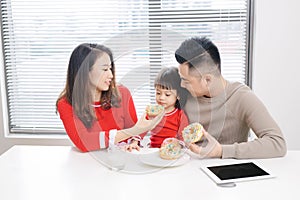 Happy young family eating pizza together and having fun