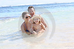 Happy young family enjoying in the sea