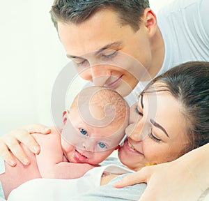 Happy young family. Father, mother and their newborn baby