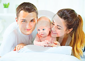 Happy young family. Father, mother and their newborn baby